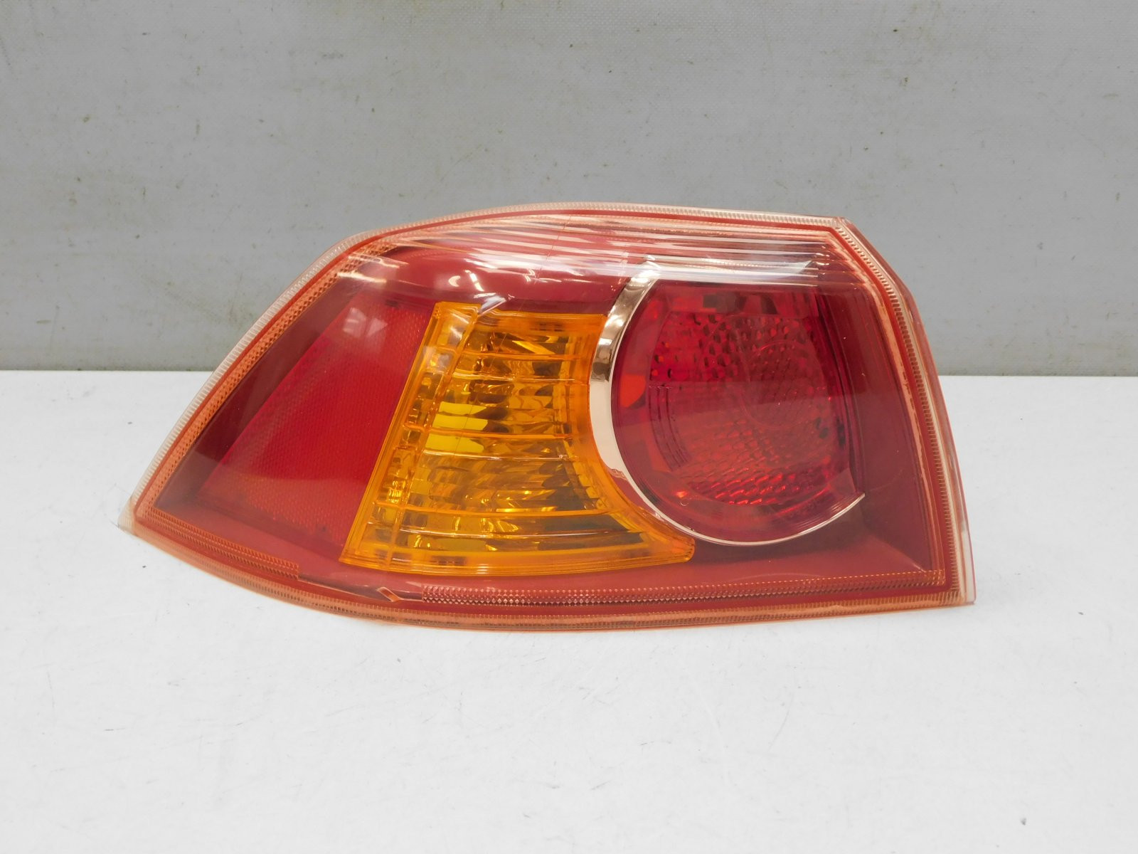 Фонарь задний наружный левый Mitsubishi Lancer 2007>